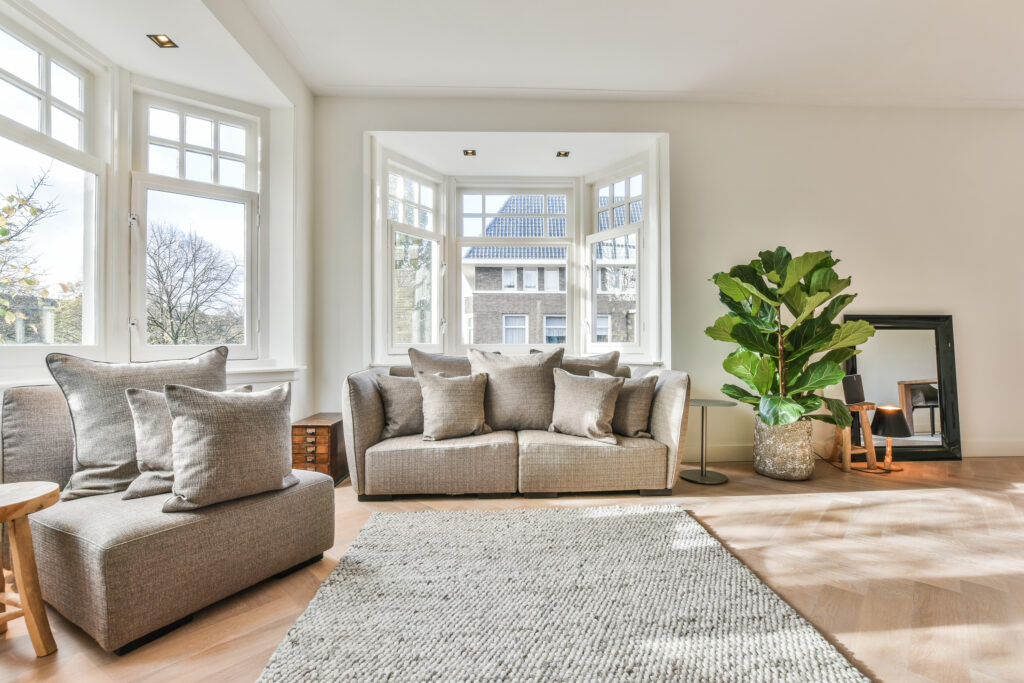 A bright and spacious living room with modern decor and large windows.