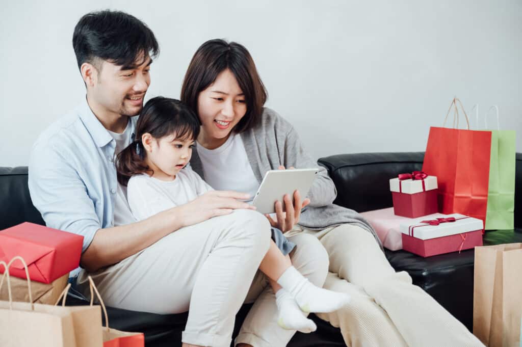 Eine glückliche Familie, die das iPad zu Hause verwendet.